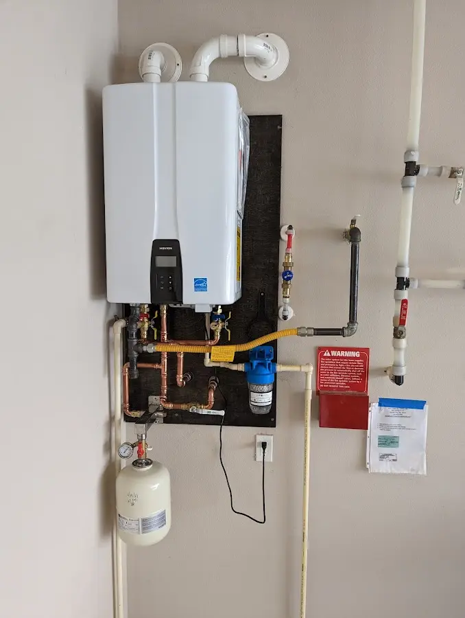 Professional plumber installing copper piping in a Rayne home